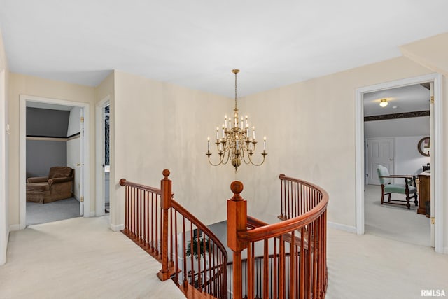 hallway featuring light colored carpet and an inviting chandelier