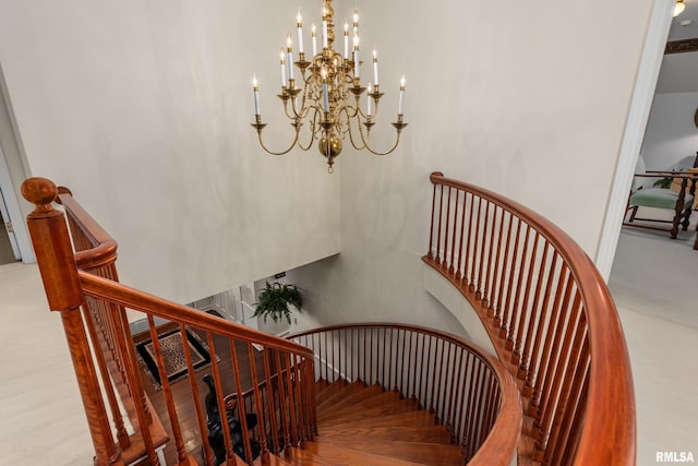 stairs with carpet and a chandelier