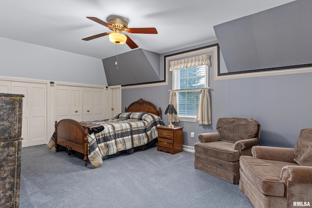 bedroom with carpet, ceiling fan, vaulted ceiling, and multiple closets