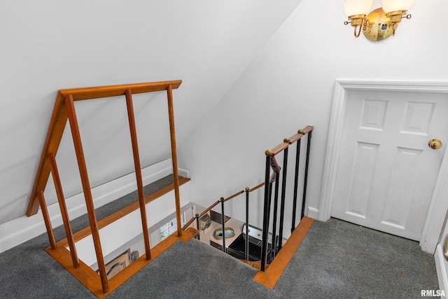 stairs with a notable chandelier and carpet