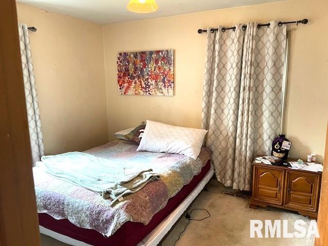 bedroom with light colored carpet