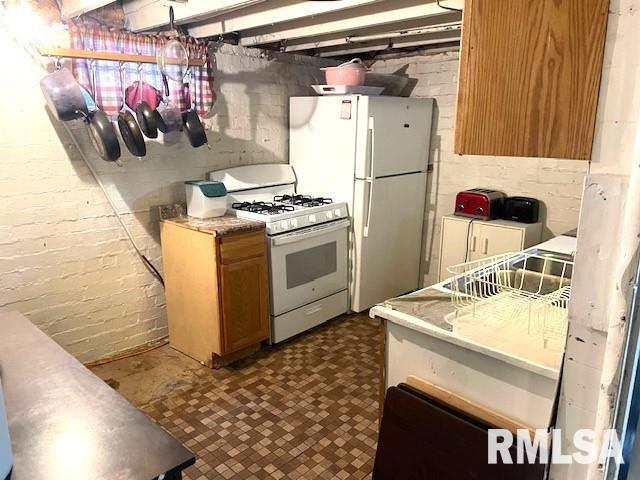 kitchen featuring white gas range and pendant lighting