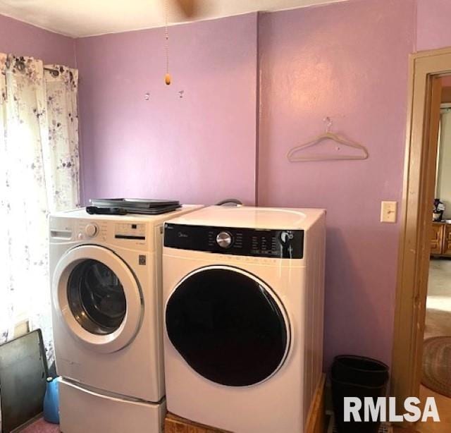 clothes washing area featuring washer and dryer