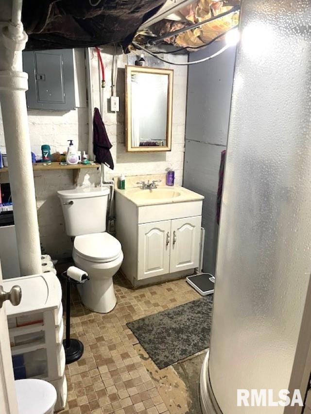 bathroom featuring a shower, vanity, and toilet