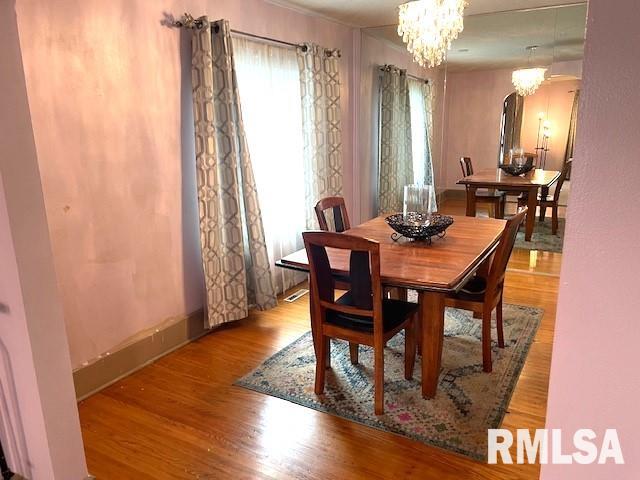 dining room featuring a chandelier and wood-type flooring