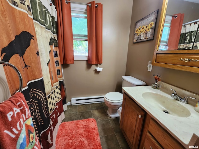 bathroom with toilet, vanity, baseboard heating, and tile patterned floors