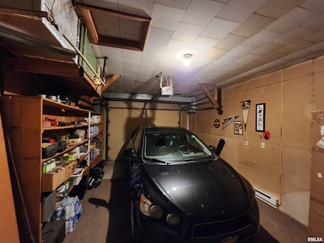 garage featuring a garage door opener and baseboard heating