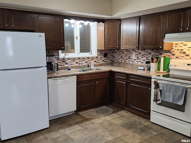 kitchen featuring dark brown cabinetry, white appliances, decorative backsplash, and sink