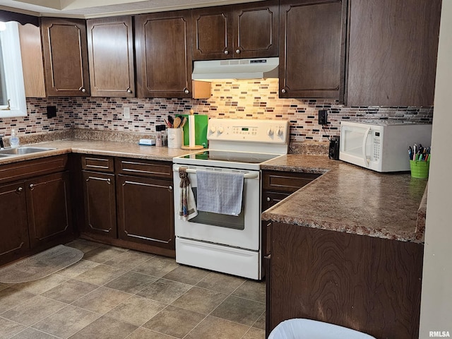 kitchen with dark brown cabinetry, white appliances, backsplash, and sink