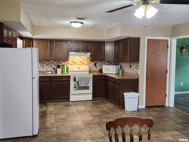 kitchen with ceiling fan, dark brown cabinetry, white appliances, and decorative backsplash