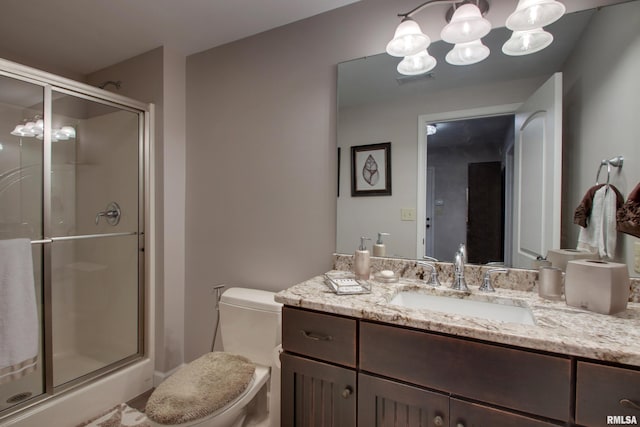 bathroom with a notable chandelier, vanity, toilet, and an enclosed shower