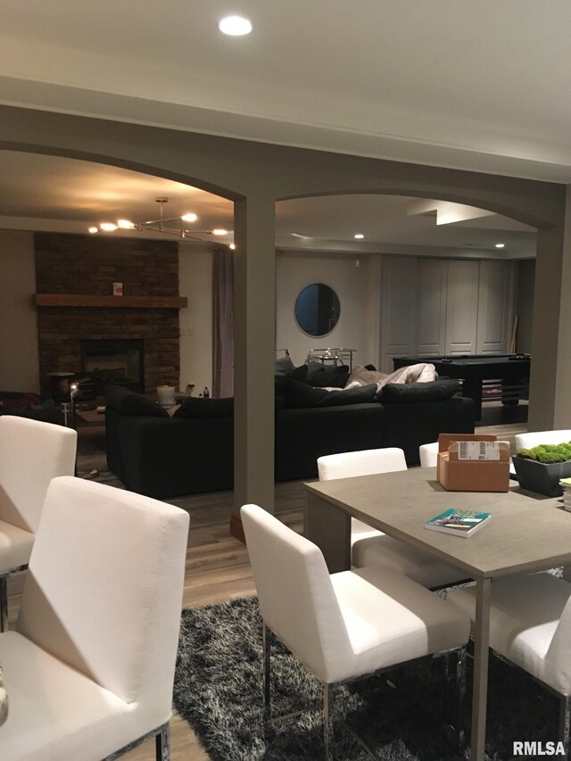 dining space featuring a fireplace and hardwood / wood-style floors