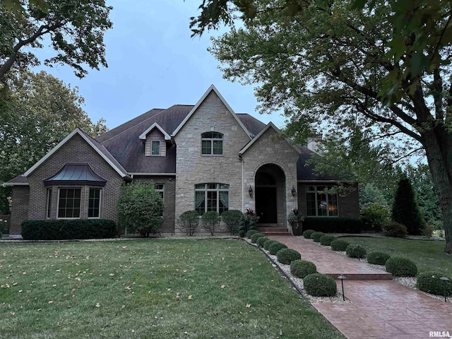 french country home featuring a front yard