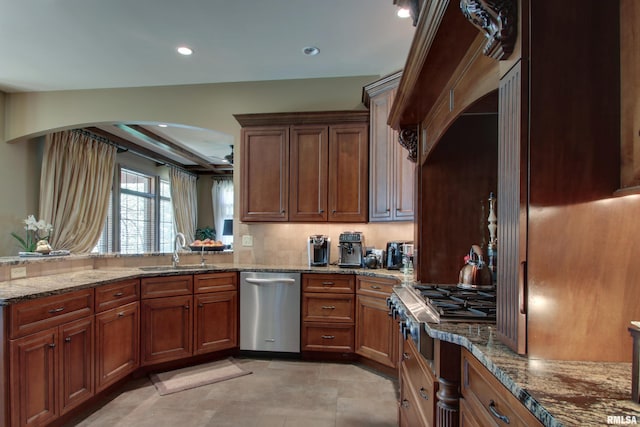 kitchen featuring dishwasher, sink, and light stone countertops