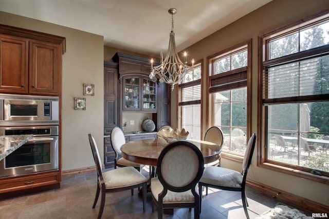 tiled dining space with a chandelier