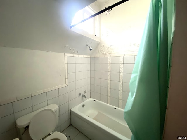 bathroom featuring shower / bath combo, lofted ceiling, tile walls, and toilet