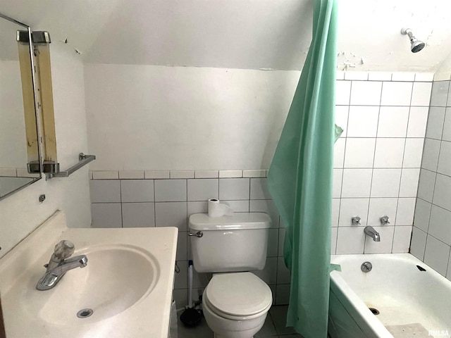 full bathroom featuring shower / tub combo with curtain, vanity, toilet, and tile walls