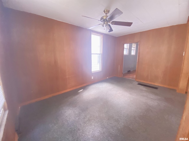 carpeted spare room with ceiling fan