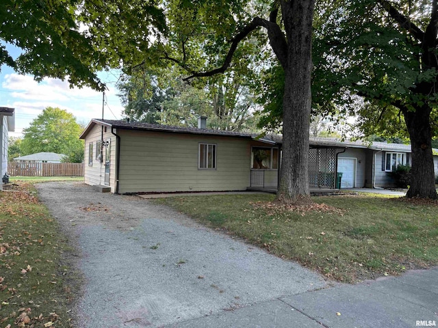 ranch-style home with a front lawn and a garage