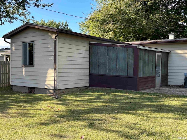 view of outbuilding featuring a lawn