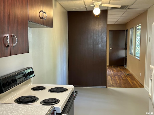 kitchen with a paneled ceiling, white range with electric cooktop, dark hardwood / wood-style floors, and ceiling fan