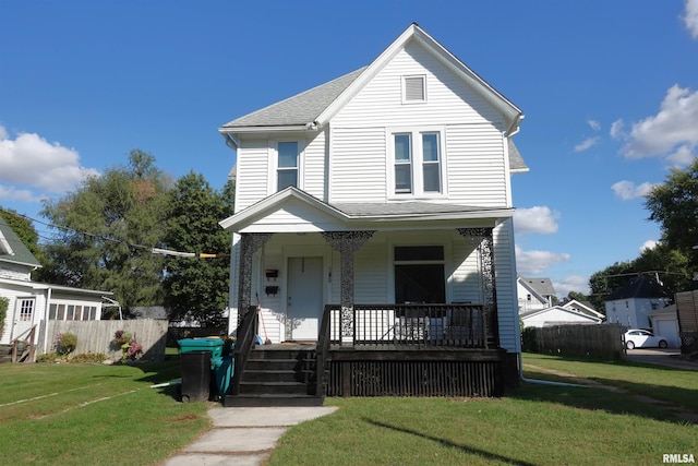 view of front of house with covered porch and a front yard