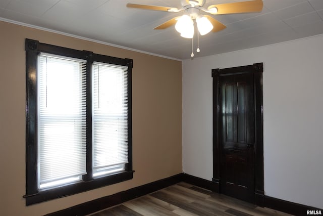 spare room with crown molding, dark hardwood / wood-style floors, and ceiling fan