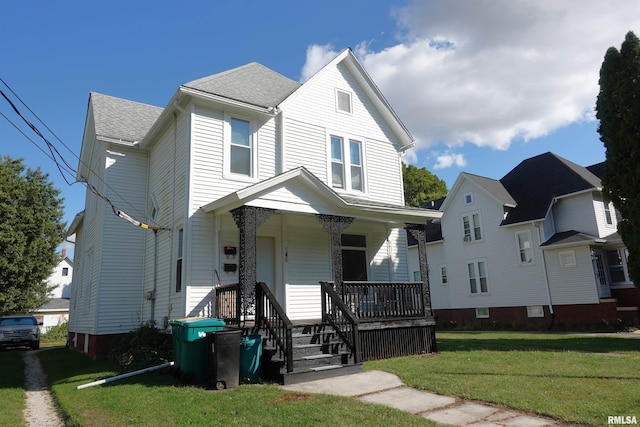 view of front facade with a front lawn and covered porch