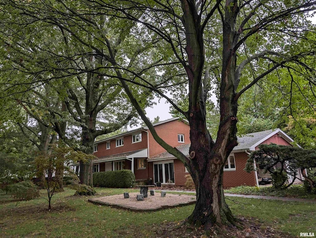 back of house featuring a patio and a lawn