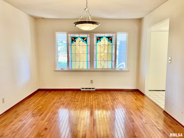 unfurnished dining area with plenty of natural light and light hardwood / wood-style floors