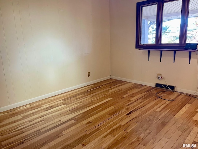 spare room featuring light hardwood / wood-style flooring