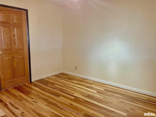 empty room with light hardwood / wood-style flooring