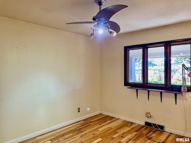 empty room featuring ceiling fan and light wood-type flooring