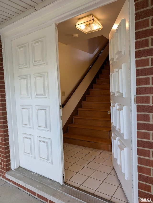 stairway with tile patterned flooring