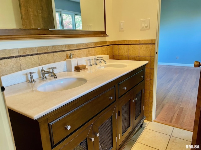 bathroom with tile walls, vanity, and tile patterned floors