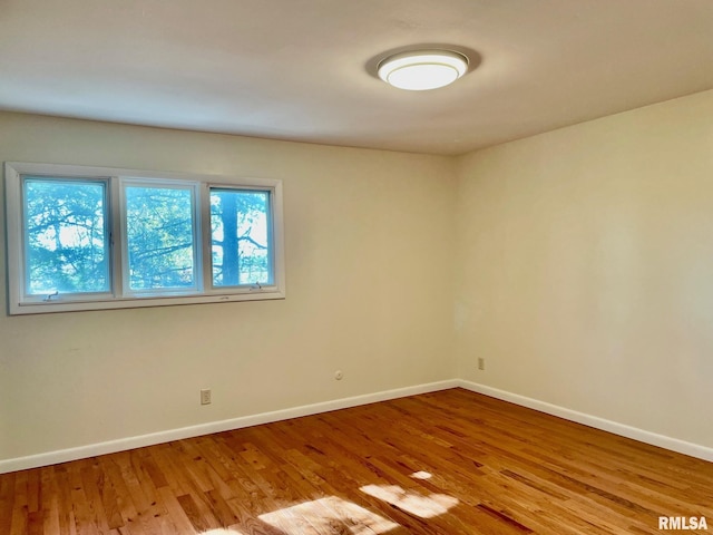 unfurnished room with light wood-type flooring