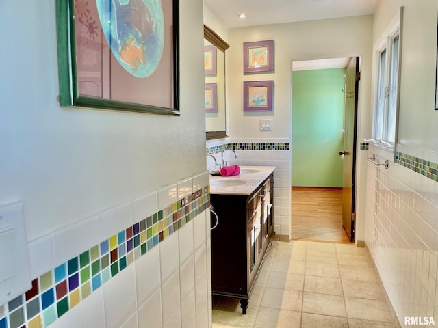 bathroom featuring vanity, tile walls, and tile patterned floors