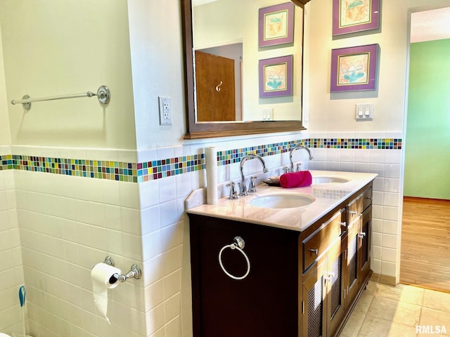 bathroom featuring vanity, tile patterned flooring, and tile walls