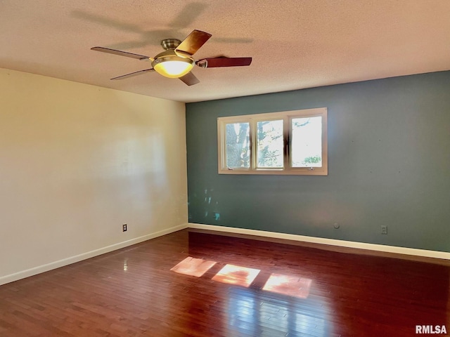 empty room with hardwood / wood-style flooring, ceiling fan, and a textured ceiling