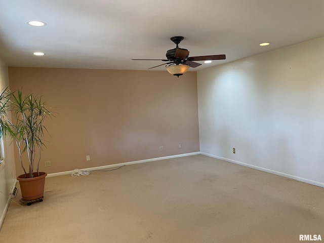 empty room featuring ceiling fan and carpet flooring