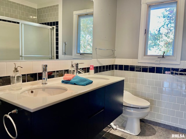 bathroom featuring tile walls, vanity, walk in shower, toilet, and tile patterned floors