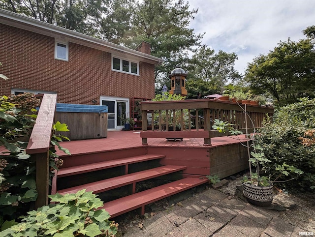 wooden terrace featuring a hot tub