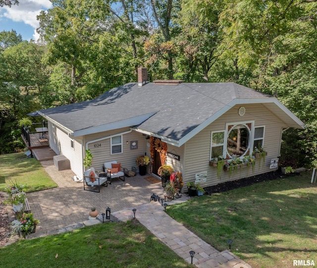 ranch-style house with a front yard and a patio area