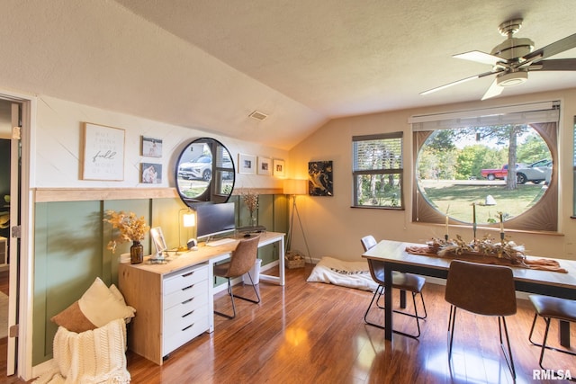 office space featuring a textured ceiling, lofted ceiling, ceiling fan, and dark hardwood / wood-style flooring