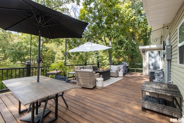 wooden deck featuring an outdoor living space and a grill