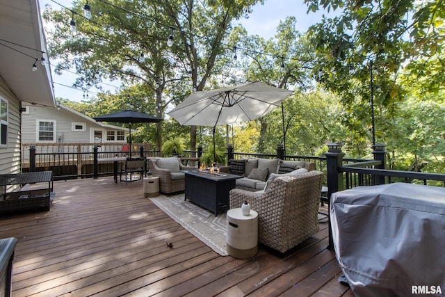 wooden deck featuring an outdoor hangout area and grilling area