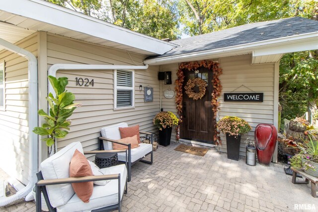 view of exterior entry with a patio area