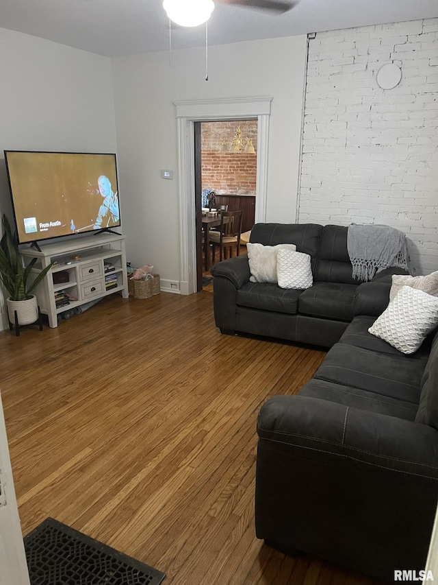 living room with ceiling fan, wood finished floors, and baseboards