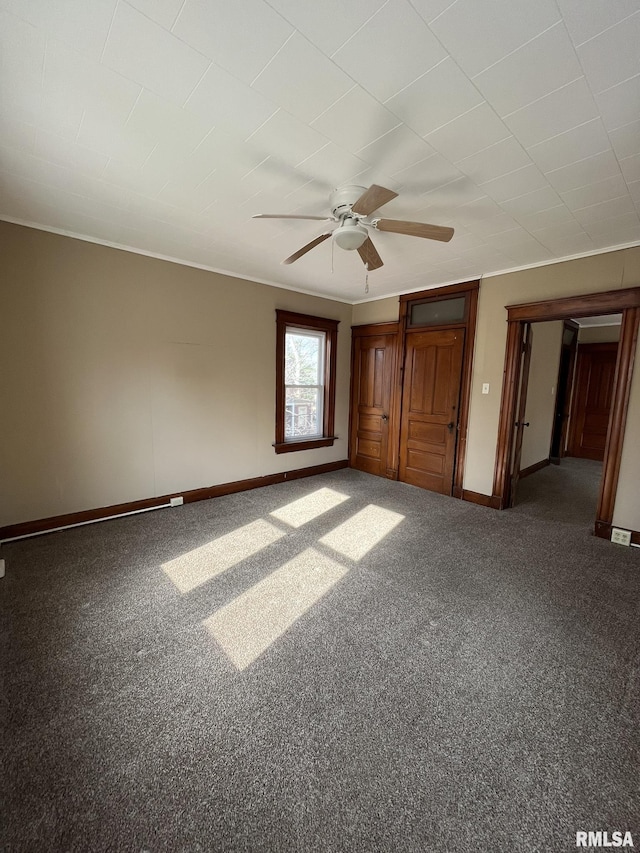 unfurnished bedroom with baseboards, carpet flooring, and ceiling fan