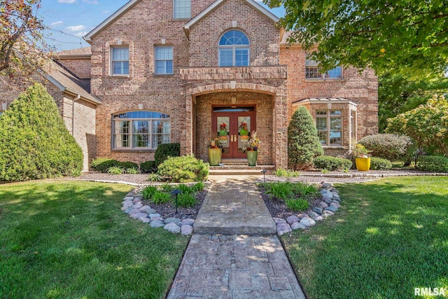 view of front of home with french doors and a front lawn